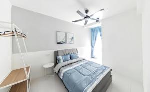 a white bedroom with a bed and a ceiling fan at Emerald Avenue Cameron Highlands in Brinchang