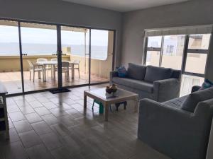 a living room with a couch and a table at 5 Telena in Umdloti