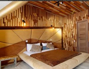 a bedroom with a large bed in a room at Four Seasons In Carpathians in Migovo