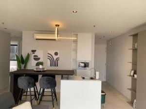 a kitchen with a counter and stools in a room at 2-Bedroom Condominium in LUMI TROPICANA in Petaling Jaya