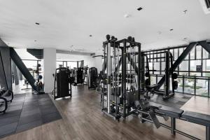 a gym with lots of equipment in a building at 2-Bedroom Condominium in LUMI TROPICANA in Petaling Jaya
