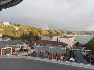 a view of a house with a rainbow in the background at Tarabya Family Suıt Boshphorus in Istanbul