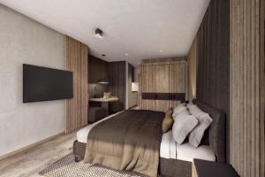 1 dormitorio con 1 cama y TV de pantalla plana en Grünwald Resort Sölden, en Sölden
