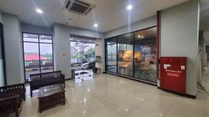 a lobby with benches and a red door in a building at OYO 93552 Tamansari Panoramic Apartment By Anwar in Bandung