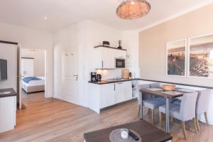 a kitchen and living room with a table and chairs at Inselhuus Norderney in Norderney