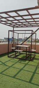 a playground with a picnic table and swings on a roof at 4 KING SIZE BEDROOM DUPLEX VILLA in Hyderabad