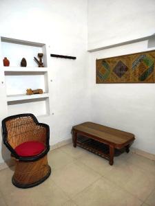 a room with a bench and a coffee table at Royal Guest House in Bharatpur