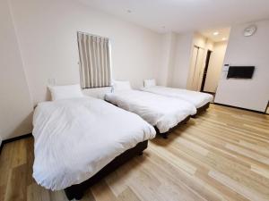 Vuode tai vuoteita majoituspaikassa KYU KYU HOTEL