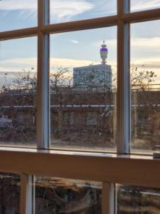 a window with a view of a lighthouse in the distance at Central location in London