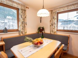 a dining room with a table with a bowl of fruit at Cozy apartment in Wald im Pinzgau with balcony and barbecue area in Wald im Pinzgau