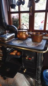 an old stove with two pans on top of it at Remig Ranch in Challand Saint Victor