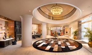a lobby of a hotel with a large room with columns at Welcomhotel by ITC Hotels, Cathedral Road, Chennai in Chennai