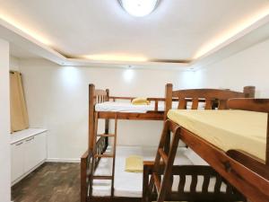 a room with two bunk beds and a kitchen at Golden Queen Suites in Baguio +13 photos