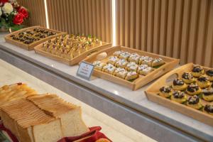 a display of different types of bread and pastries at BlueSun Danang Beach Hotel in Da Nang +37 photos