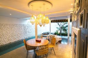 a dining room with a table and chairs at Calm Villa in Seminyak