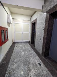 an empty room with a garage door in a building at ABP Studio's in Ghaziabad