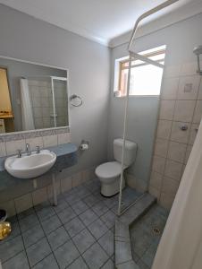 a bathroom with a toilet and a sink at Toodyay Hotel in Toodyay