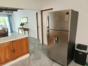 a kitchen with a large stainless steel refrigerator at Fairy-Tern Chalets Cerf Island in Cerf Island