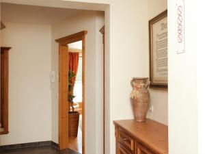 a hallway with a vase sitting on a wooden table at Apartment in Saalbach-Hinterglemm with sauna in Saalbach-Hinterglemm