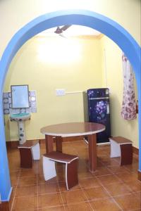 a room with a table and a desk and a computer at VM Residency in Yelagiri