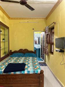 a bedroom with a bed and a tv in a room at VM Residency in Yelagiri