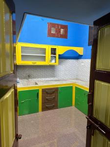 a small kitchen with a microwave on the wall at VM Residency in Yelagiri