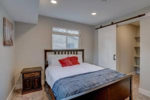 1 dormitorio con 1 cama con 2 almohadas rojas en Comfortable Modern Home w/ Game Room, en American Fork