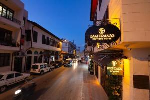 a street with cars driving down a city street at Sam Franss Boutique Otel in Hatay