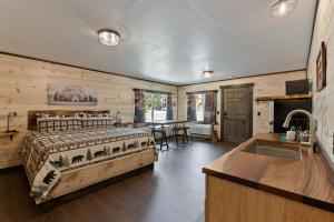 a bedroom with a bed and a kitchen with a table at Lake Village Lodge in Coeur d'Alene