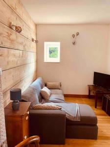 a living room with a couch and a table at Jolie maison à la campagne « Chez Germaine » in Digosville +35 photos