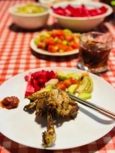 a plate of food with meat and vegetables on a table at EUROPEAN Backpackers Hostel in Tbilisi City