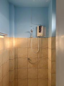 a bathroom with a shower with a shower head on the wall at Srisomthai Hotel in Ubon Ratchathani