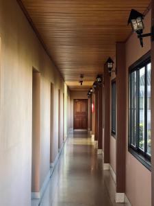 an empty hallway of a building with a wooden ceiling at Srisomthai Hotel in Ubon Ratchathani