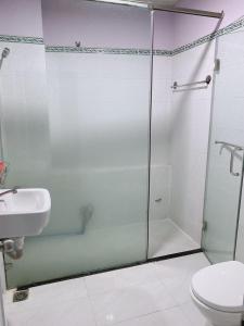 a bathroom with a shower and a toilet and a sink at Thanh Thảo Hotel - 57/4 Lê Quang Qịnh, Q. Bình Thạnh - by Bay Luxury in Ho Chi Minh City