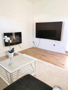 a living room with a coffee table and a flat screen tv at Årsta strand in Stockholm