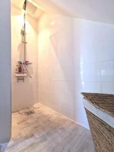 a bathroom with a shower with white tiles at Årsta strand in Stockholm