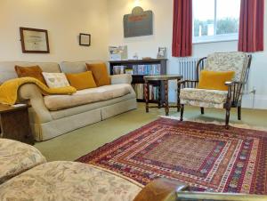 a living room with a couch and a chair at Rowden Mill Station in Bromyard