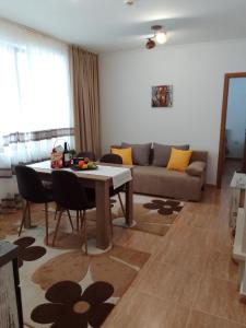 a living room with a table and a couch at Апартамент за гости 4а26 Планинска Магия Grand Monastery Пампорово in Pamporovo