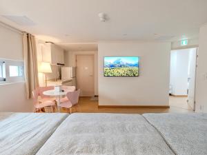 a bedroom with a bed and a table with chairs at Harmony Stay in Seoul