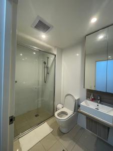 a bathroom with a shower and a toilet and a sink at 2-bedroom security apartment with free parking on premises in Riverwood