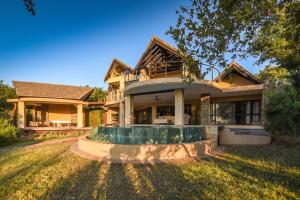 a large house with a large yard at Impangele River Lodge in Hectorspruit