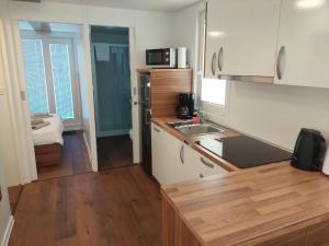 a small kitchen with white cabinets and a sink at HOUSE BOAT OLIVA - Floating House in Pula