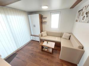 a small living room with a couch and a table at HOUSE BOAT OLIVA - Floating House in Pula +25 photos