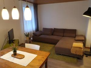 a living room with a couch and a table at Bed n Bureau Roggwil in Roggwil