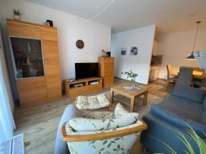a living room with a blue couch and a table at Ferienwohnung von Damm in Bad Harzburg