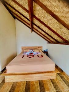 a bedroom with a bed in a room at Bali Sunrise Cabin in Bangli
