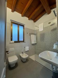 a bathroom with a toilet and a sink at B&B Michelina in Castiglione dʼIntelvi