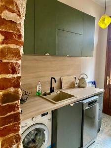 a kitchen with a sink and a washing machine at Central High class 3 Bedroom Apartment in Sofia