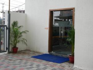 a door with a blue mat in front of a building at Zip By Spree Hotels Bhopal in Bhopal