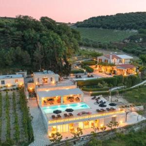 an aerial view of a building with a pool at Villa Mantilari Wine Estate 7 Apartments 2 Private Pools 1 Heated Tennis Court Fitness Center in Archanes